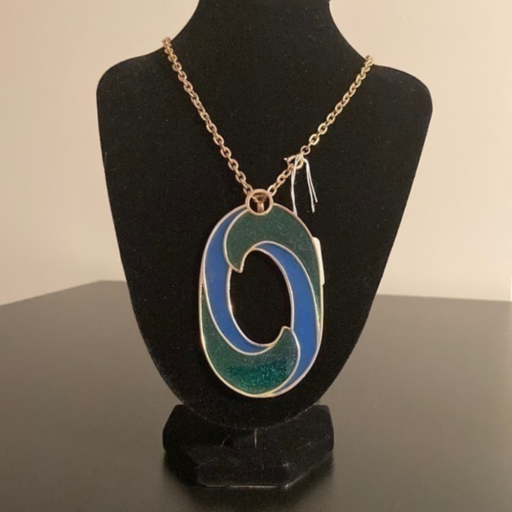 Long JJ necklace with green and blue pendant.